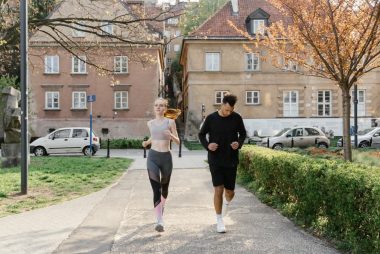 A couple jogging together in an urban park, enjoying outdoor exercise.